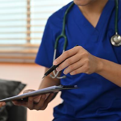 stock photo of a doctor handing a clipboard to a patient